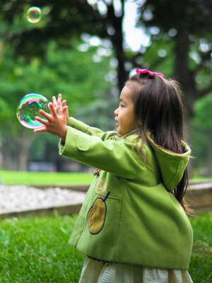 Child playing with bubbles